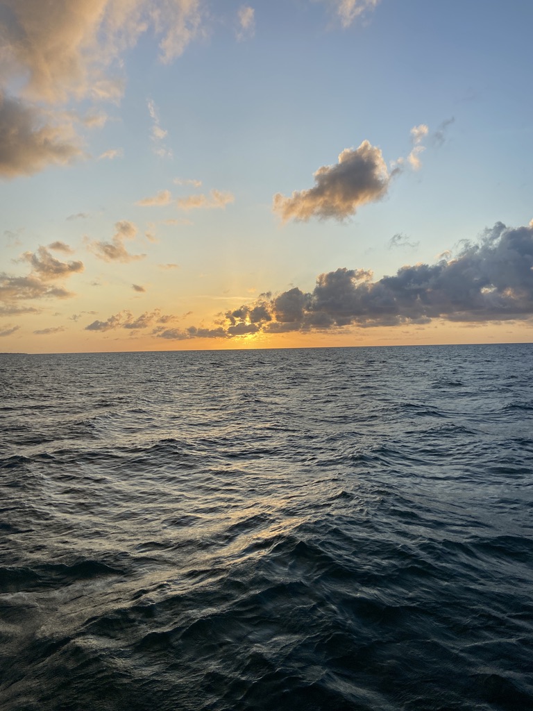 Beholding a stunning sunset amidst the vast expanse of the ocean. At Barefoot Ocean, we aim to equip individuals, small-scale fishing communities, and both local governmental and non-governmental organizations with the tools and insights of science and data to drive positive change